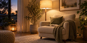 Warm floor lamp beside an oatmeal reading chair with gentle background lighting