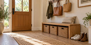Low oak entryway storage bench with woven baskets, wall hooks and a clear walkway