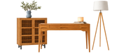 Wooden desk and storage cabinet styled with a vase, books, and tripod floor lamp